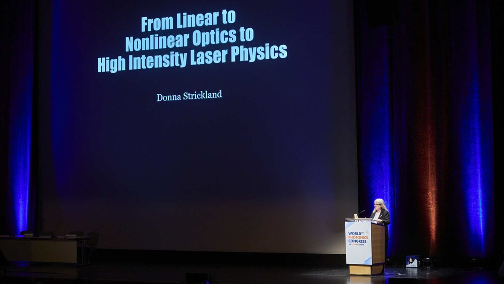 A woman presents a projected slide entitled 
