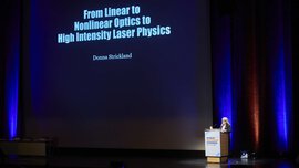 A woman presents a projected slide entitled 