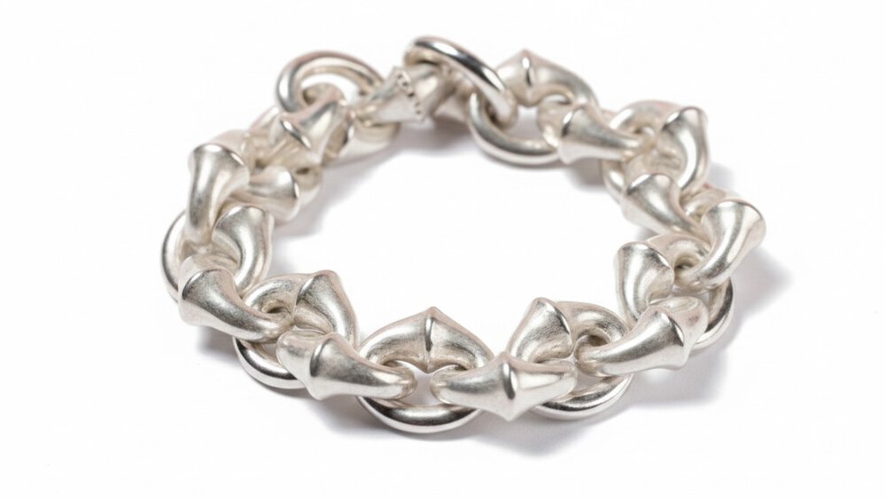 The close-up view of a multi-link bracelet with a slightly dull silver sheen, resting on a white background.