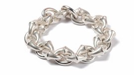 The close-up view of a multi-link bracelet with a slightly dull silver sheen, resting on a white background.
