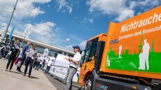 A male exhibitor explains his solution to one of the challenges facing the environmental industry to a group of participants on the IFAT Munich Solution Tour