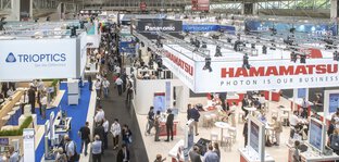 Bird's eye view of exhibition hall A2, with many well-attended exhibition stands.