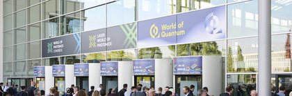 Participants enter the main entrance of Messe München for the World of Quantum 2025 trade fair.
