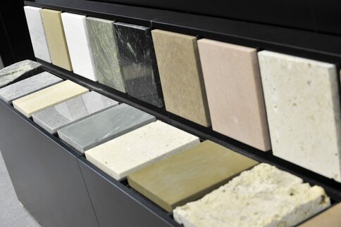 Various rectangular stone and marble patterns in different colors, available on shelves for selection.