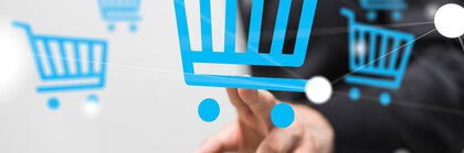 One person's hand points to the symbol of a blue shopping trolley floating in the air in front of her along with others.
