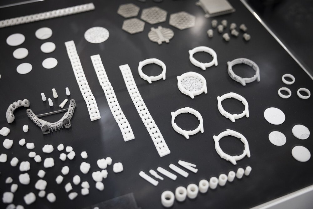 Various white and grey geometric pieces arranged on a black surface.