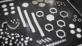 Various white and grey geometric pieces arranged on a black surface.