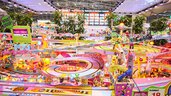 A very colorful carrera track with all kinds of advertising stickers, at an exhibition stand.