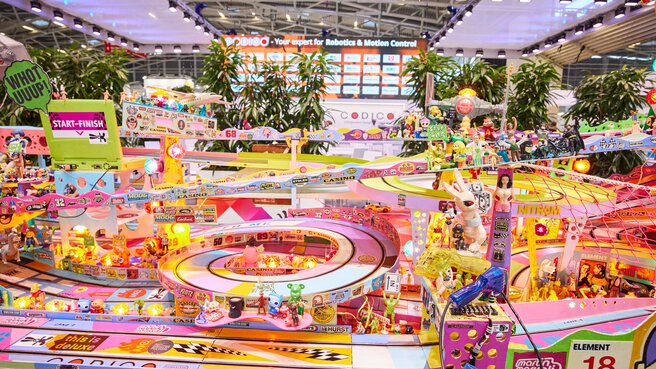 A very colorful carrera track with all kinds of advertising stickers, at an exhibition stand.