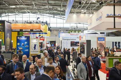 Well-attended exhibition hall at transport logistic with numerous colourful exhibition stands.