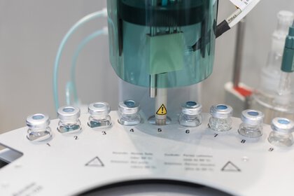 Several vials are embedded in round holders in an analyzer