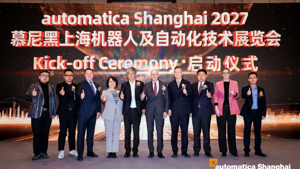 Group of participants on stage at the automatica Shanghai 2027 kick-off ceremony in front of a large event screen.