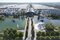 Aerial view of a modern exhibition center with fountains, ponds, trees and large buildings in the background.