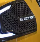 Close-up of a radiator grille of an electric vehicle with illuminated 