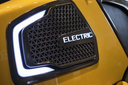 Close-up of a radiator grille of an electric vehicle with illuminated 
