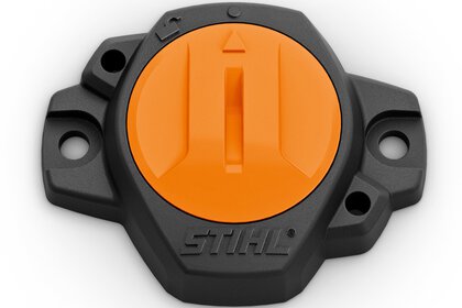 Stihl tool part in black and orange with mounting holes and arrow marking in the centre.