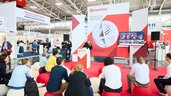 Presentation on the ceramitec stage with a seated audience in an exhibition hall.