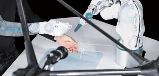 In a futuristic environment, a robotic arm interacts precisely with a person's gloved hand.
