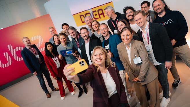 Group of participants taking a selfie during the DMEA nova award ceremony on a DMEA stage