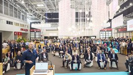 View from the stage in Hall C2 of a large crowd of seated and standing spectators.