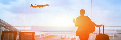 happy traveler waiting for the flight in airport