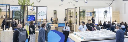 Hydrogen and circular economy stand at IFAT Munich with visitors and information displays.