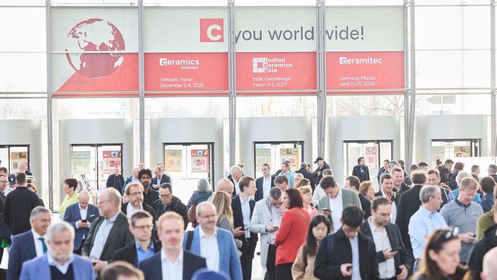Crowds of visitors in the exhibition entrance area with ceramitec signage.