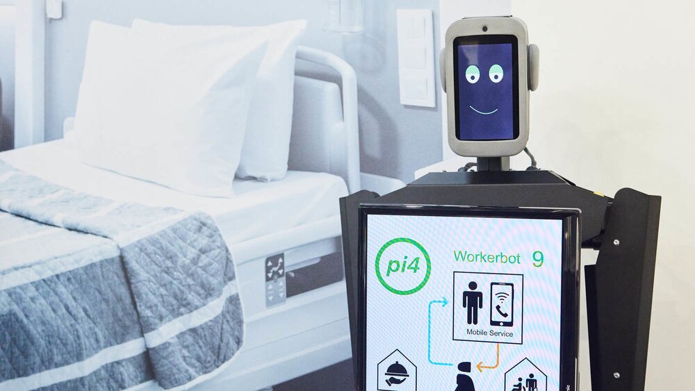 Hospital robots with digital face display and touchscreen in a modern medical environment.