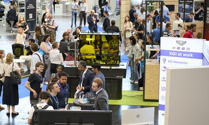 Besucher und Messestände auf dem Messegelände der World of Quantum