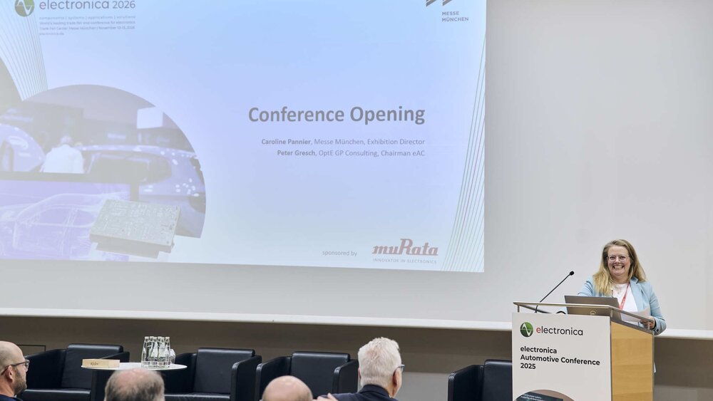 A woman speaks on stage during the opening of the electronica Automotive Conference 2025.