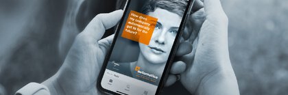 Close-up of a smartphone in the hands of a person on which the automatica app can be seen.