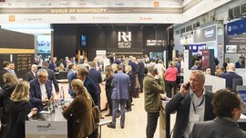 A large exhibition stand at EXPO REAL labeled “World of Hospitality.”