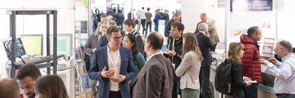 A well-attended LOPEC trade fair where people interact with each other in the exhibition space and explore the exhibitors' stands.