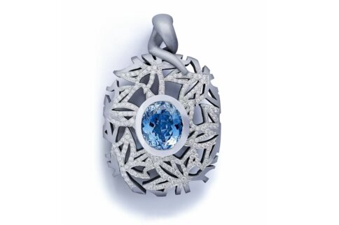 Ein kunstvolles Schmuckstück mit kleinen Diamanten auf den Verzweigungen und einem großen blauen ovalen Edelstein in der Mitte.