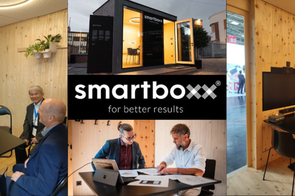 Modern meeting room with wooden walls, people discussing at a table. Central logo: “Smartboxx for better results”