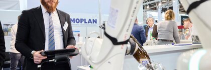Visitor controls robotic arm during live demonstration