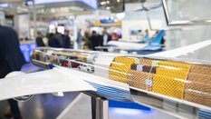 Model of a cargo plane with a transparent fuselage at an exhibition stand at transport logistic.