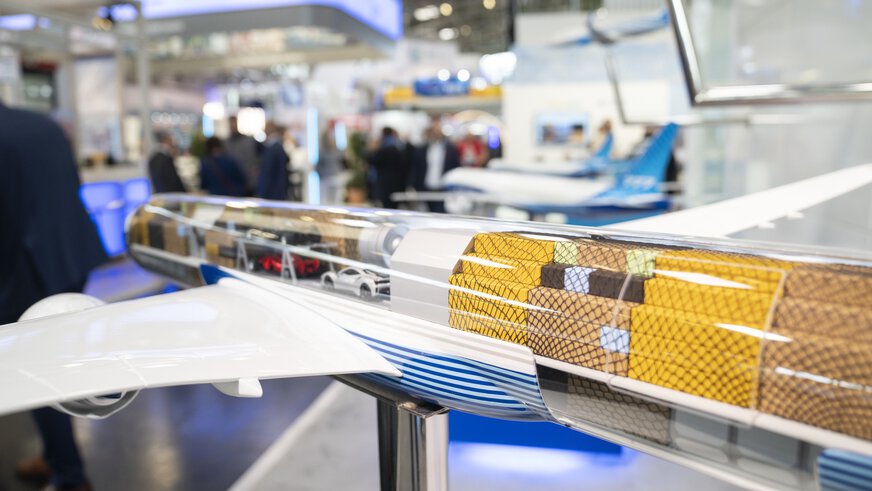 Model of a cargo plane with a transparent fuselage at an exhibition stand at transport logistic.
