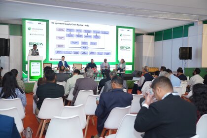 Expert panel presenting on Indian supply chains to a seated audience at a conference.