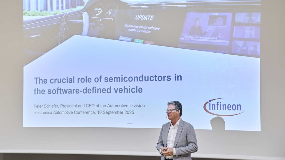 A man presents a slide about semiconductors in vehicles at an Infineon conference.