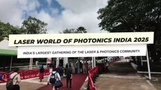 Start image for the Laser World of Photonics India 2025 video showing trade fair visitors walking along a red carpet.