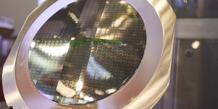 A round construction with a metal frame and many small rectangular, shimmering semiconductor boards.
