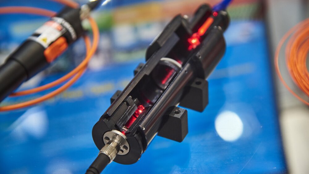 Close-up of a cross-sectional model of a laser exhibited at a trade fair stand.