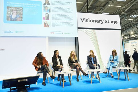 Five women sit on the stage of the electronica Visionary Stage during a panel discussion.