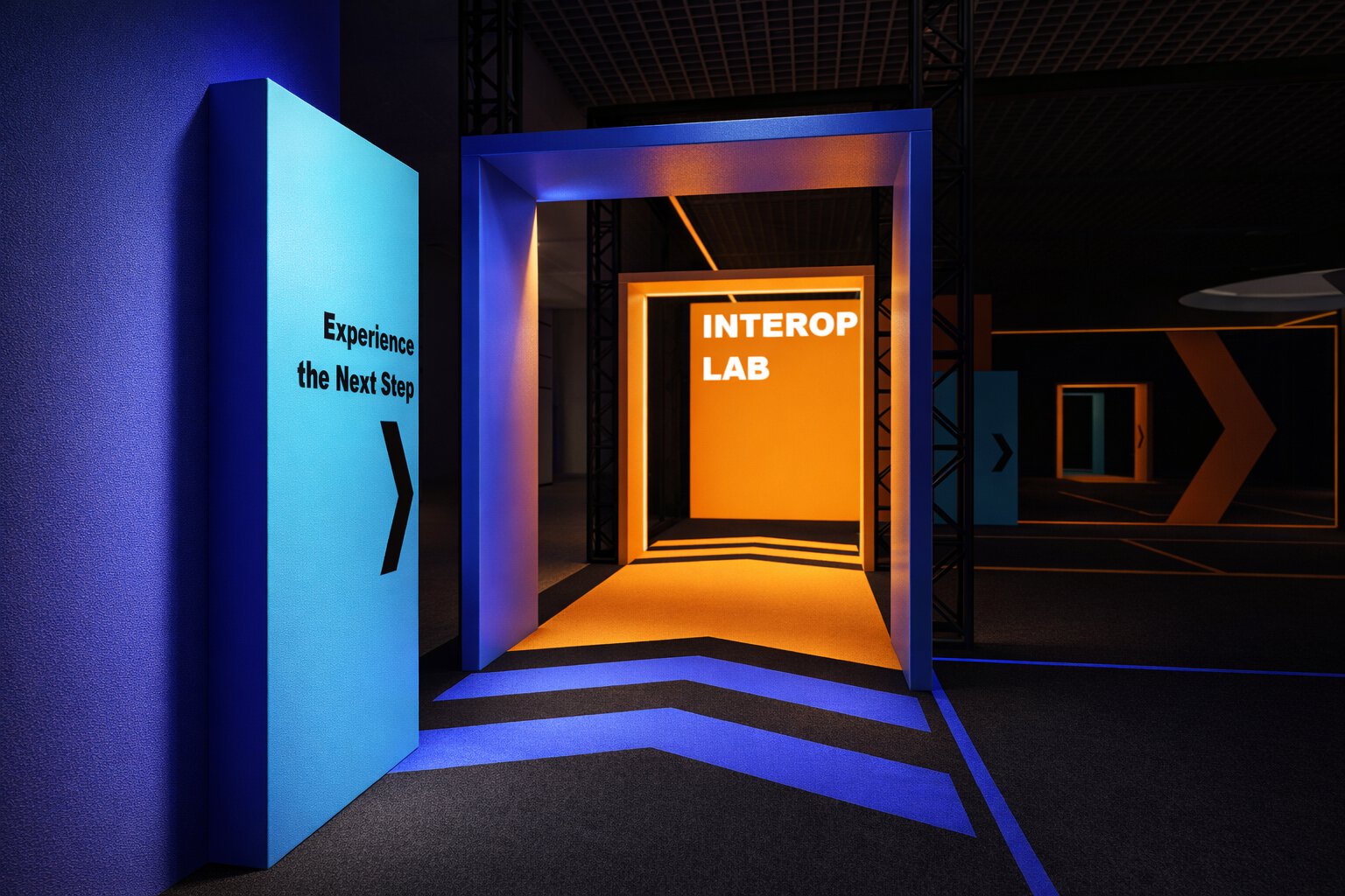 A three-dimensional representation of a corridor, consisting of blue and orange-lit arches and arrows on the floor, along with the text ‘Experience the Next Step’.