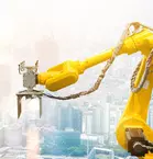 A yellow robot arm in front of a cityscape with tall buildings in the background.