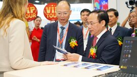 Several men in suits with elaborate floral arrangements on their lapels are standing at a counter looking at a card.