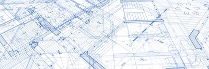 Close-up of detailed blue architectural plans with lines, dimensions and technical drawings.