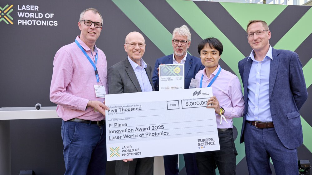 Handing over the check on stage to the Innovation Award winners 2025
