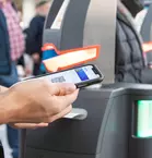 Person scans QR code with smartphone at the entrance to the bauma exhibition area.